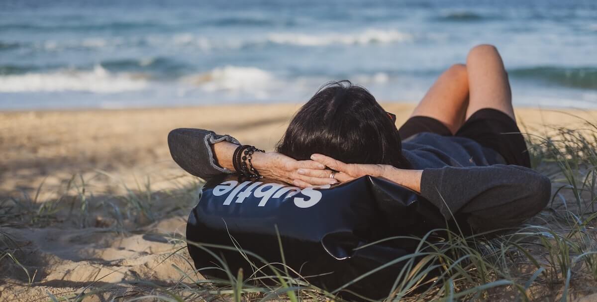 person taking a nap at the beach