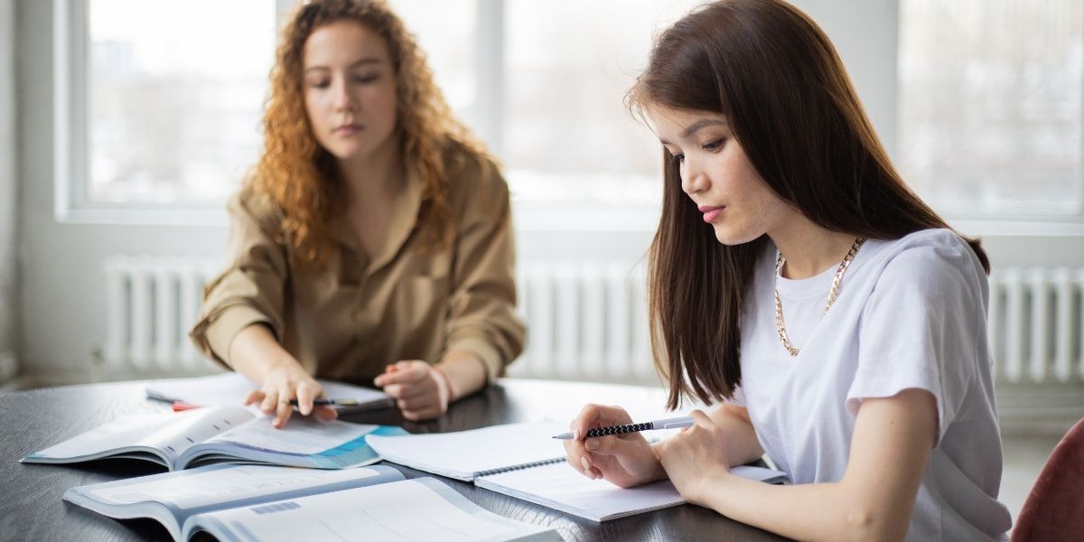 two women studying at library